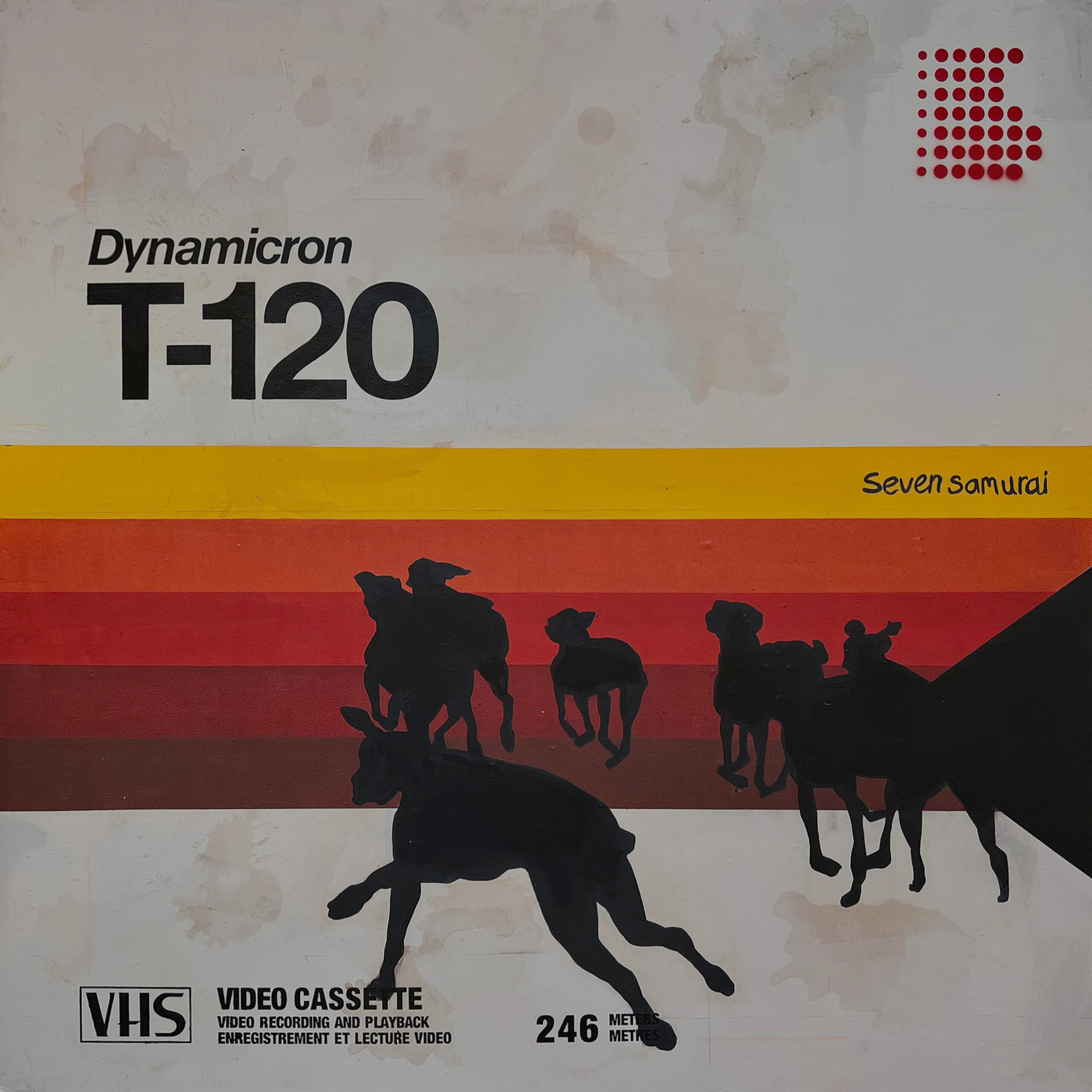 Black silhouettes of dogs run towards horizontal red, orange and yellow bands beneath the graphics and lettering of a Dynamicron T-120 VHS cassette.
